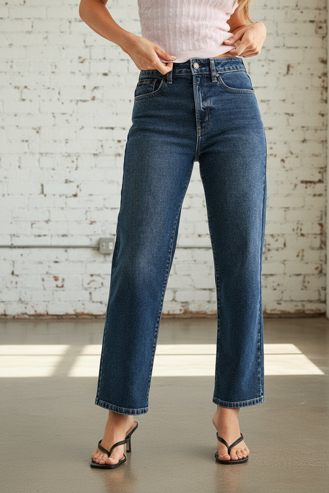 Person wearing blue jeans on a white background