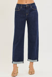 Dark blue jeans with rolled-up cuffs on a white background
