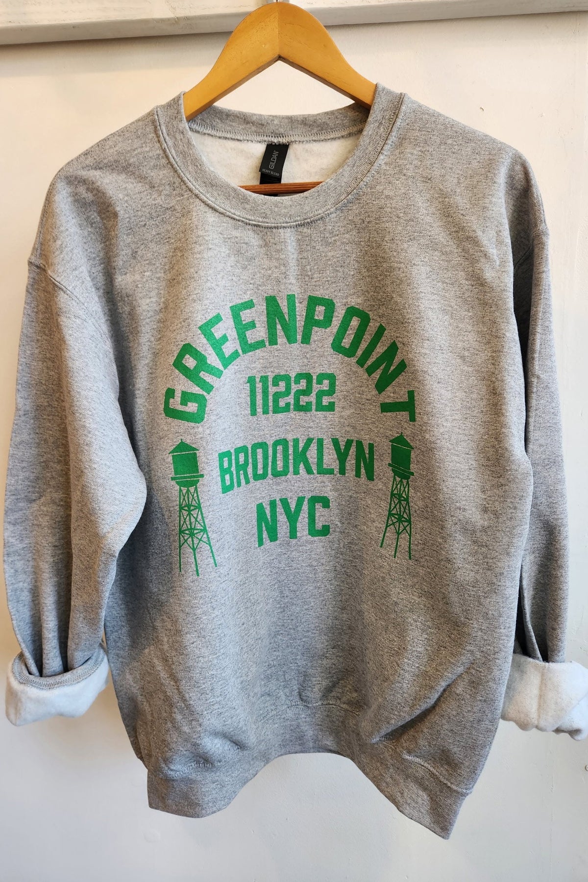 A gray sweatshirt with 'GREENPOINT 11222 BROOKLYN NYC' printed in green on the front.
