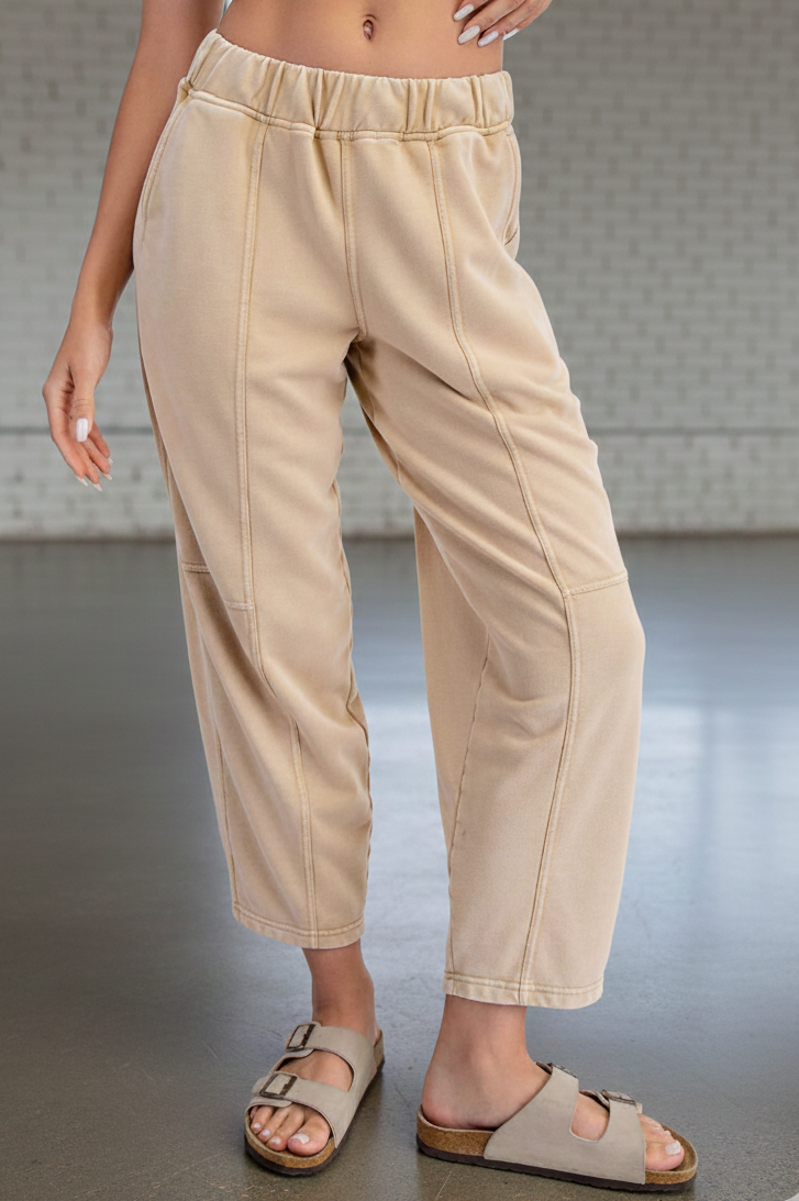 Person wearing beige pants with a neutral background