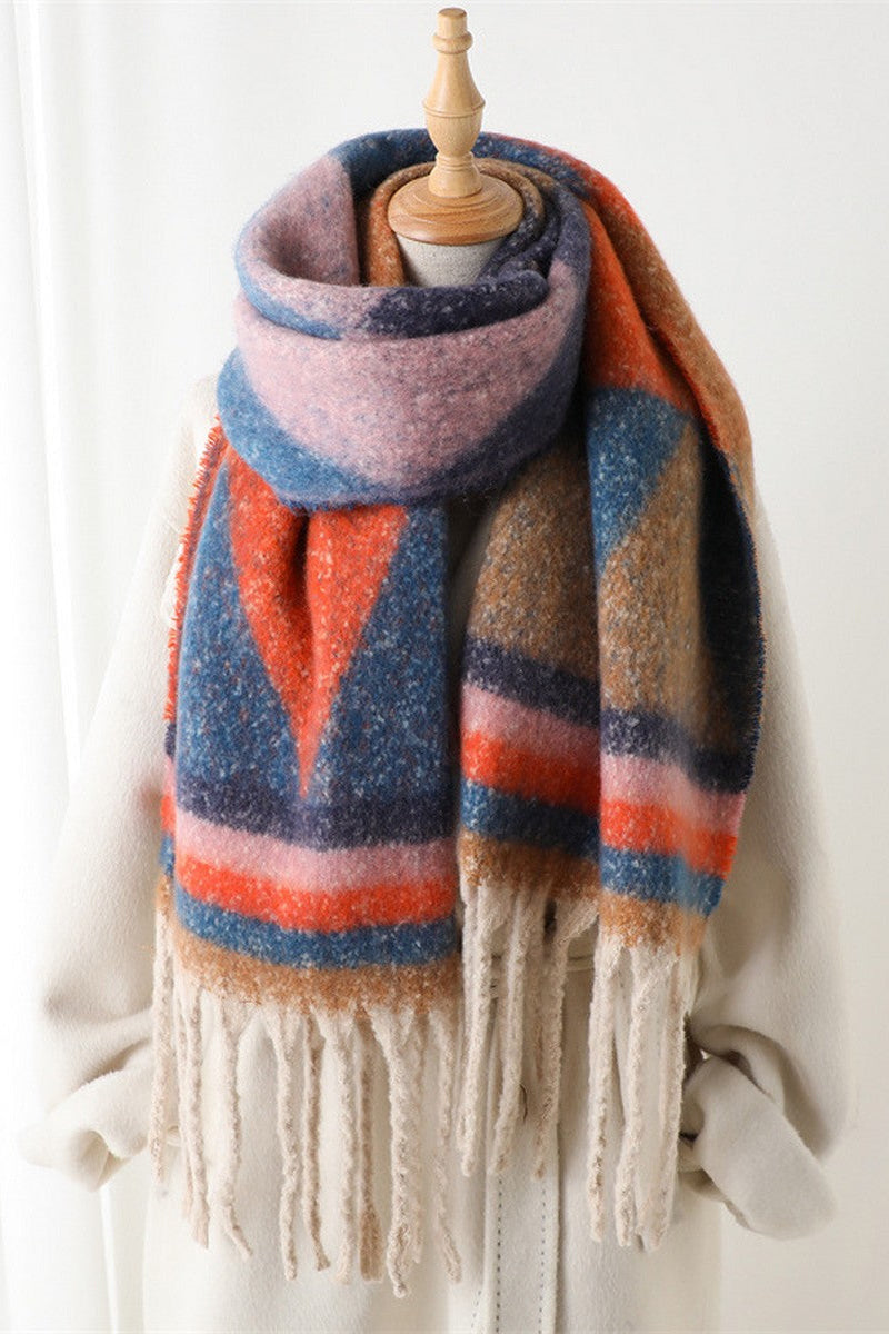 Colorful striped scarf with fringes on a mannequin against a white background