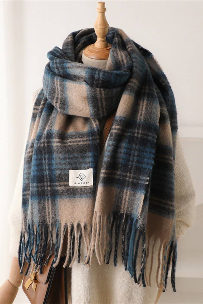 Plaid scarf with tassels on a mannequin against a white background