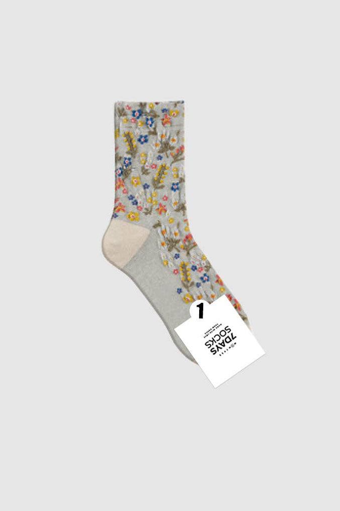 Floral-patterned sock with a gray heel and toe on a white background