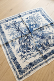 Blue and white floral patterned fabric on a wooden surface