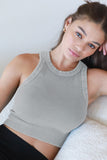 Woman wearing a gray crop top sitting on a white surface with 'Vintage Cool Grey' text.