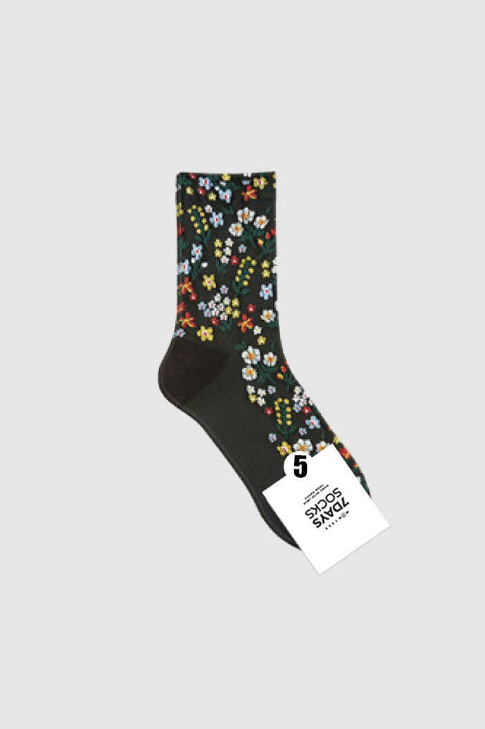 Floral-patterned sock with a brand tag on a light gray background