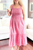 Woman in a pink dress standing in a modern living room.