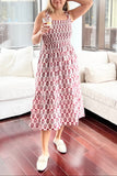 Woman in a patterned dress standing in a modern living room.