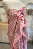 Pink floral patterned scarf on a mannequin with a blurred indoor background