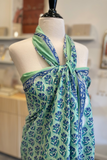 Green and blue patterned scarf on a mannequin in a store setting