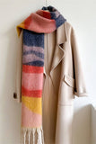 Beige coat with a colorful striped scarf on a white background