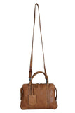 Brown leather handbag with a strap on a white background
