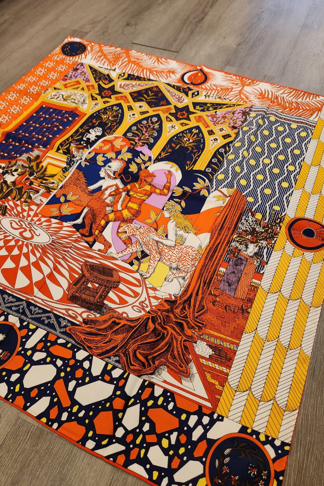 Colorful abstract patterned scarf on a wooden floor