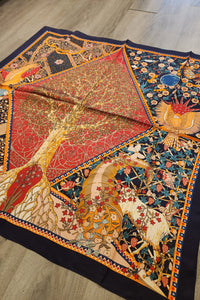 Decorative quilt with intricate patterns on a wooden floor