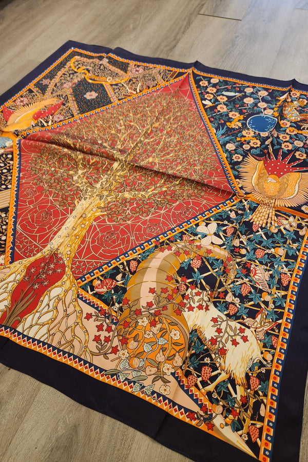 Decorative quilt with intricate patterns on a wooden floor