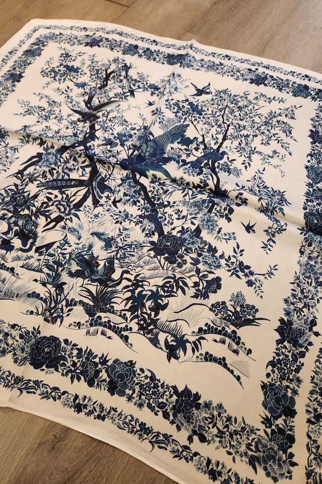 Blue floral and bird pattern on a beige fabric