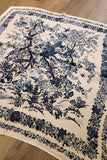 Blue floral and bird pattern on a beige fabric