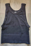 Black ribbed tank top on a wooden surface