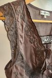 Brown lace lingerie set on a hanger with 'Raisènè' label.