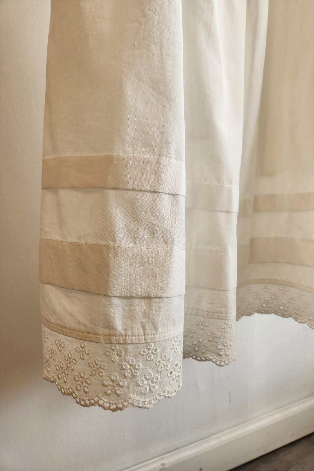white skirt with eyelet  lace detailing on a white background