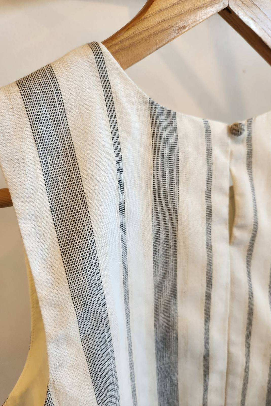 Striped shirt on a hanger with a neutral background